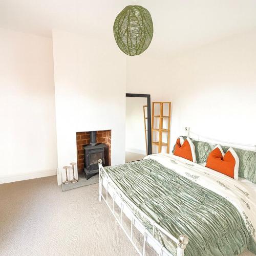 a bedroom with a bed and a fireplace at Tanshelf House - Pontefract Town Centre in Pontefract