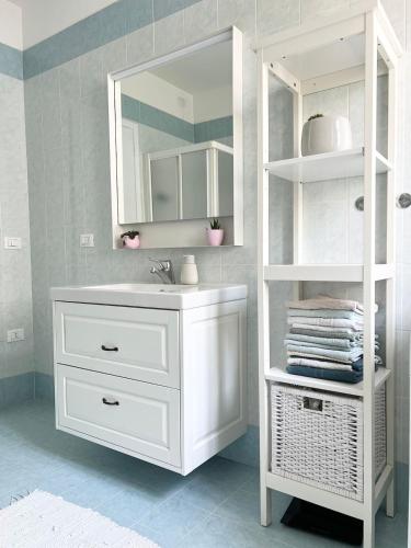 a white bathroom with a sink and a mirror at Apartment near Treviso in Silea in Silea