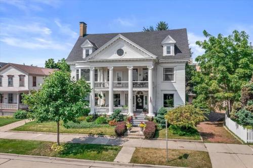 a large white house with a porch at Gorgeous Historical Mansion on the Lake Front in Racine
