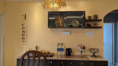 a room with a counter with a microwave and a chair at Seneh Homes in Guwahati