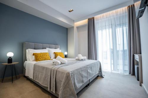 a bedroom with a large bed and a large window at Aether, Light Modern Living in Gaïtánion