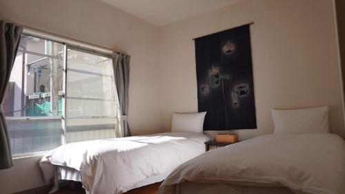 Ένα ή περισσότερα κρεβάτια σε δωμάτιο στο Ikebukuro