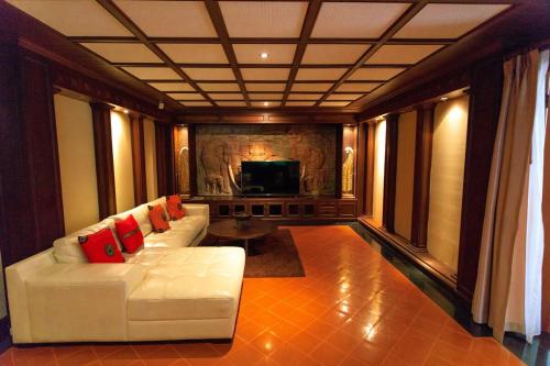 a living room with a white couch with red pillows at Classic Cozy Thai Villa BIG pool Party OK in Patong Beach
