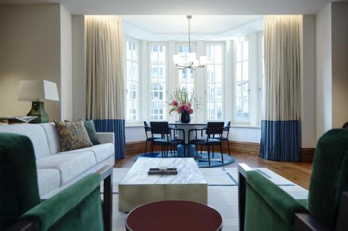 a living room with a couch and a table at Conrad Hamburg in Hamburg