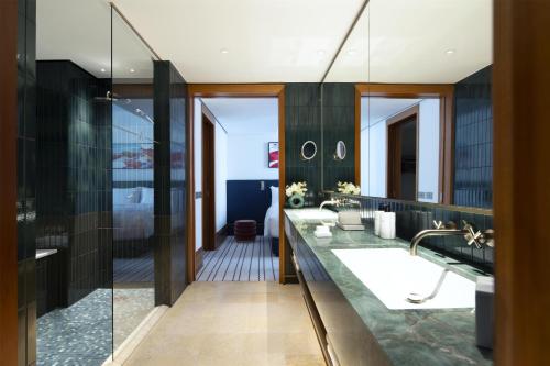 a bathroom with a shower and a sink at Conrad Hamburg in Hamburg