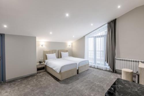 Ένα ή περισσότερα κρεβάτια σε δωμάτιο στο Novo Sky Boutique