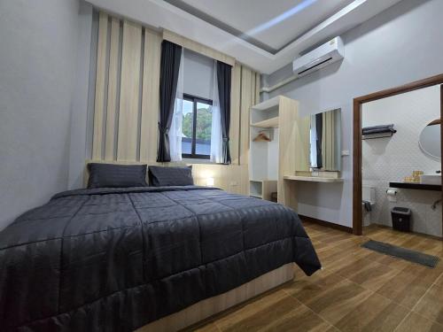 a bedroom with a bed and a large window at TiTIME POOL VILLA in Ao Nang 