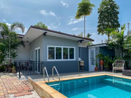 a house with a swimming pool in front of it at Thawat Villa Boutique Resort in Ko Lanta