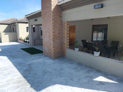 a patio outside of a house with a table and chairs at Family Home In Maun in Maun