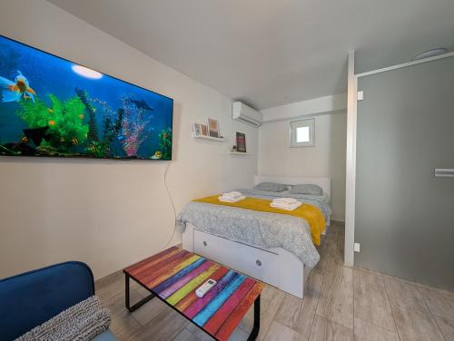 a bedroom with a bed and a fish painting on the wall at Secluded Studio in Central Sesvete in Sesvete