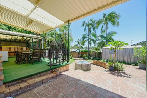 an outdoor patio with a table and chairs and a fence at Casula cozy 3Br home with parking & WiFi 