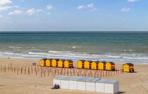 a row of colorful beach huts on the beach at 1 Bedroom Nice Apartment In De Panne in De Panne