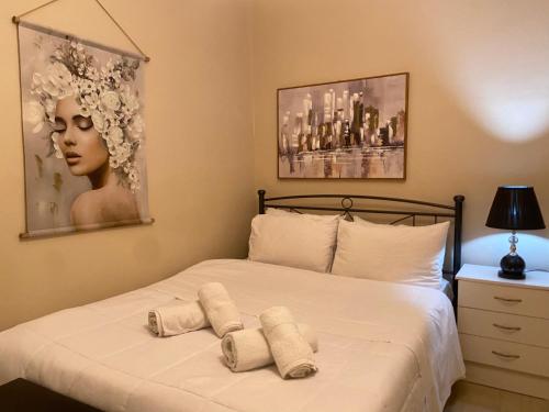 a bedroom with a bed with two towels on it at Maria’s apartment in Amfilochía