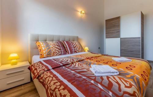 a bedroom with a bed and a night stand with a lamp at House Ivica in Banjole