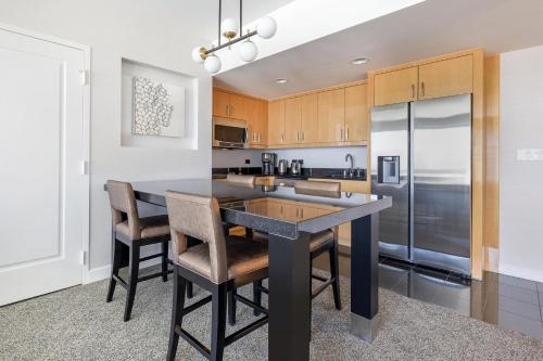 a kitchen with a large island with bar stools at Hilton Grand Vacations Club Elara Center Strip Las Vegas in Las Vegas