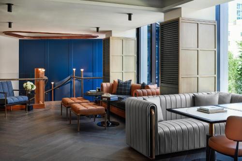 a lobby with a couch and a table and chairs at The George Manhattan, Tapestry Collection By Hilton in New York