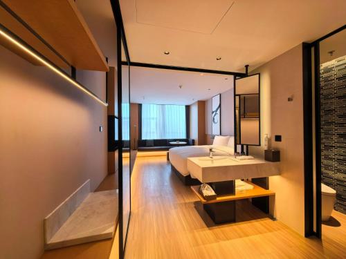 a bedroom with a bed and a large mirror at Fairfield by Marriott Hangzhou Future Sci-tech City in Hangzhou