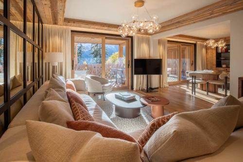 a living room with a couch and a table at Antarès URSA 303 - luxury apartment ski inski out in Méribel