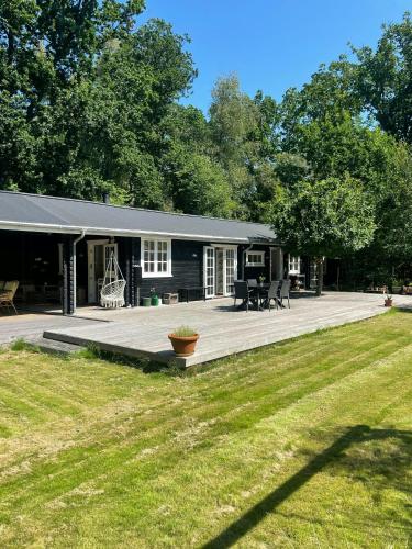 a house with a large porch and a patio at Holiday Home By Nyrup Bay And Rørvig Harbour in Rørvig