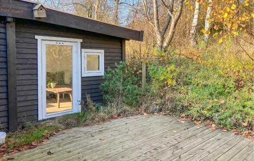 a small cabin with a door and a patio at 3 Bedroom Lovely Home In Skibby in Rønø