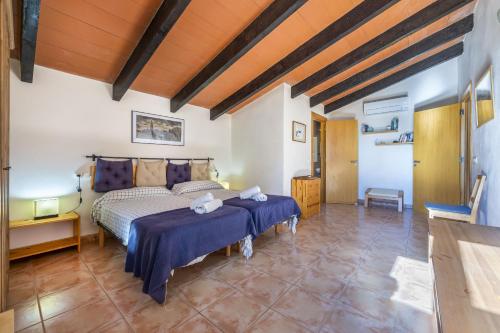 a bedroom with a bed and a wooden ceiling at Mercedes in Santa Margalida