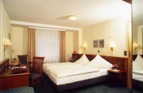 Pokój hotelowy z łóżkiem i biurkiem w obiekcie Landgasthof Deutsches Haus w mieście Ulmbach