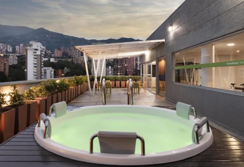 a bath tub on the roof of a building at Hampton by Hilton Medellin in Medellín