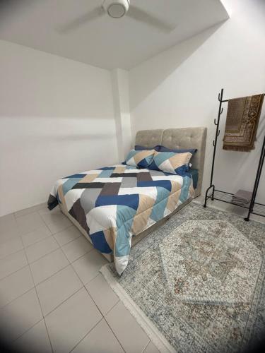 a bedroom with a bed and a ceiling fan at Coach homestay in Kuantan
