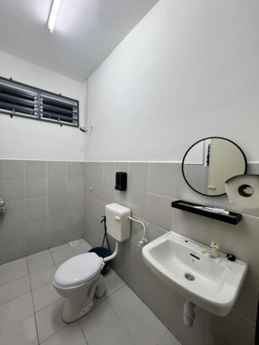 a bathroom with a toilet and a sink at Coach homestay in Kuantan