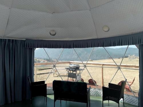 a room with a table and chairs and a large window at Stunning Off-Grid Dome with Spectacular Views for a Unique Glamping Getaway in Montana in Plains