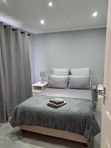 a white bedroom with a large bed with towels on it at Aqua Farm - Family Unit in Teba