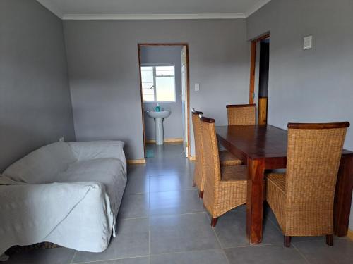 a living room with a table and chairs and a couch at Aqua Farm - Family Unit in Teba