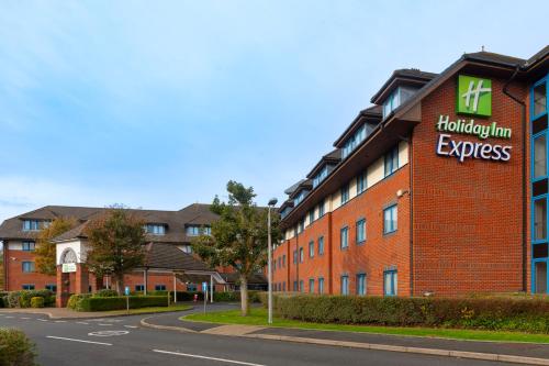 a red brick building with the highton inn express sign on it at Holiday Inn Express Birmingham Airport NEC by IHG in Bickenhill