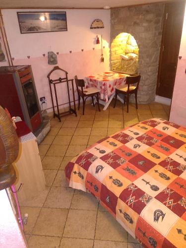a bedroom with a bed and a table and chairs at camera per 2 persone con il cuore in relax in Sarre