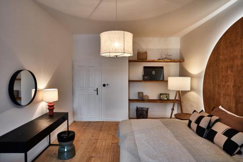 a bedroom with a bed and a table and a mirror at Zámek Žďár in Žďár nad Sázavou