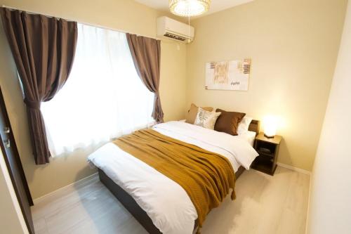 Postel nebo postele na pokoji v ubytování South Wind STAY Naha Uema