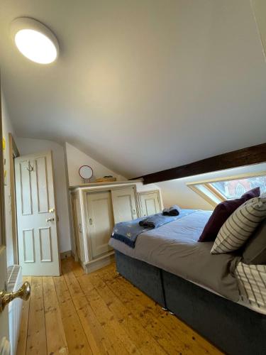 a bedroom with a large bed in a room at One bedroom loft apartment central Worcester in Henwick