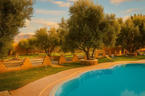 an overhead view of a swimming pool with trees and chairs at EdenAtlas Chambres d'hôtes - Amizmiz in Amizmiz