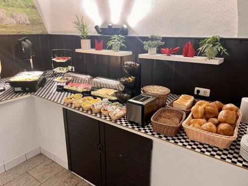 a bakery counter with bread and pastries on it at DH Hotel Deutsches Haus - Ihr neuer Rückzugsort im Herzen von Mittweida, digitales Hotel im historischen Gebäude in Mittweida