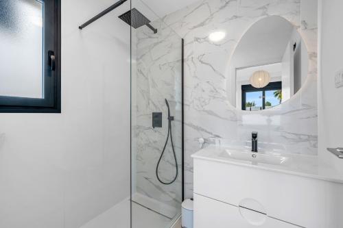 a bathroom with a shower and a sink and a mirror at Casa Jette in San Miguel de Salinas