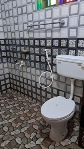 a bathroom with a toilet and a sink at Aura Eco Friendly Resort in Sultan Bathery