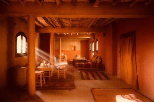 a living room with a couch and a table at EdenAtlas Chambres d'hôtes - Amizmiz in Amizmiz