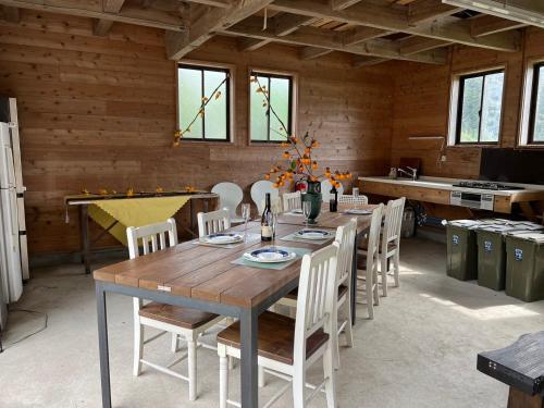 a dining room with a wooden table and chairs at Oasis Minamiboso in Minamiboso