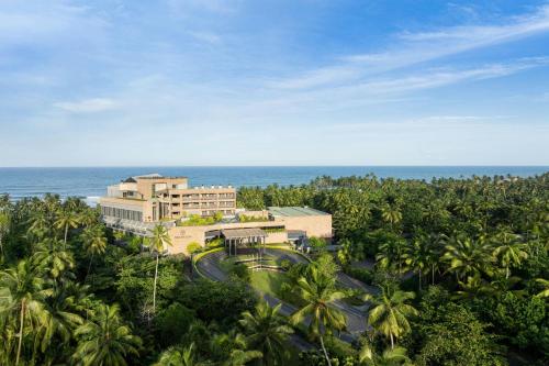 an aerial view of a resort with palm trees and the ocean at Sheraton Kosgoda Turtle Beach Resort in Bentota
