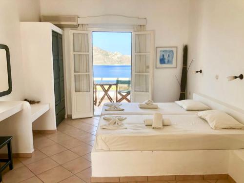 Ένα ή περισσότερα κρεβάτια σε δωμάτιο στο Agios Pavlos Studios