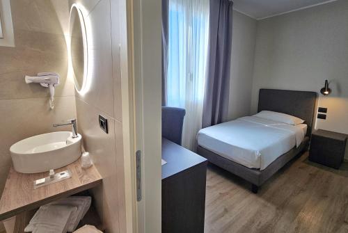 a small bathroom with a bed and a sink at Hotel Ristorante al Giardinetto in Colle Umberto