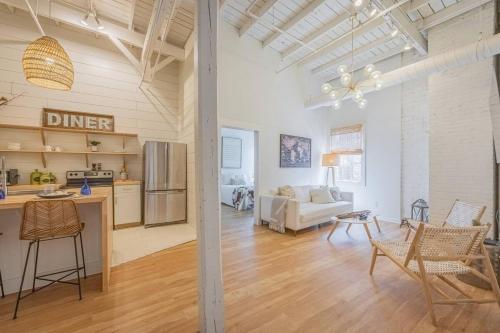 a kitchen and a living room with a table and chairs at Darlin Downtown Dawghouse in Athens