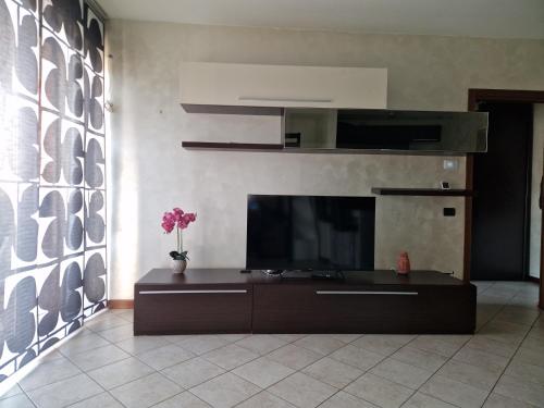 a living room with a flat screen tv on a wall at Casa di Mike in Canegrate