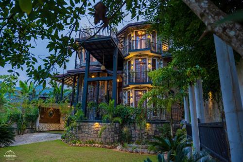 a large house with a stone wall at Winterfell Bandarawela in Bandarawela