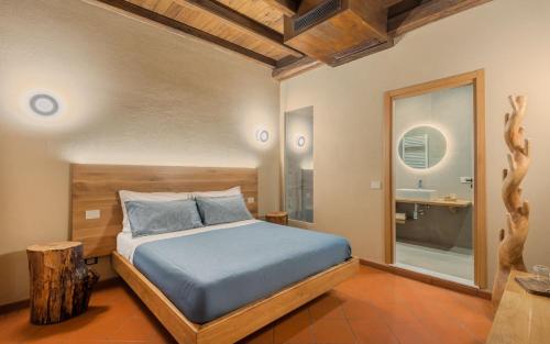 a bedroom with a bed and a bathroom at Sarzana-Charming Room Pool and BB in Sarzana